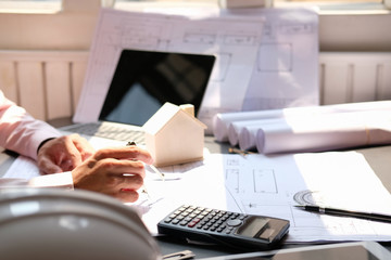 architect engineer working on house blueprint of real estate project at workplace. construction & building concept