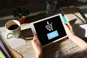 Online payment an e-commerce concept. Pay button on tablet screen.