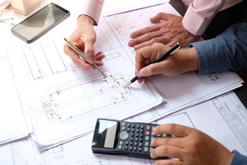 architect engineer team working on house blueprint of real estate project at workplace. construction & building concept