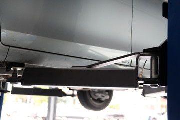 car on lift in automobile repair service