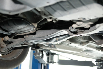 car on lift in automobile repair service