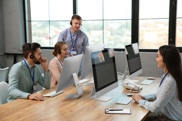 Technical support operators working in modern office