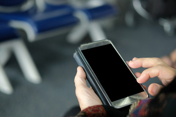 hand holding mobile smart phone at airport