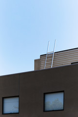 Roof top ladder on modern apartment building.