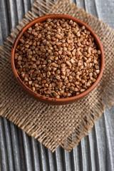 Grain buckwheat on a gray wooden background