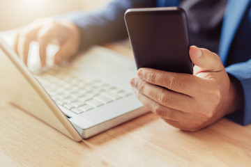 businessman use laptop and smartphone for work hard.