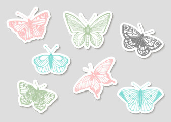 Fototapeta na wymiar Vector set of hand drawn black and white stickers with butterflies. Engraving vintage illustration in pastel colors. Realistic insects isolated on grey background. Detailed graphic drawing