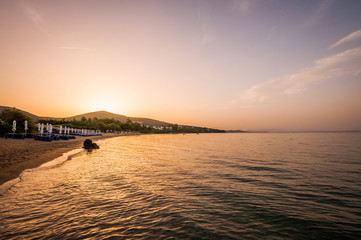 Fototapeta premium Paralia Gerakinis, Sithonia, Chalkidiki, Greece - June 29, 2014: Dawn on the beach in the village Paralia Gerakinis on the peninsula Sithonia