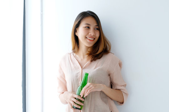 Young asian women drinking beer and smiling with happiness, lifestyle
