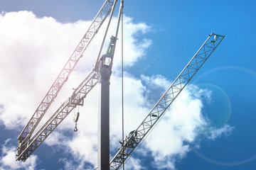 Fototapeta premium Crane on blue sky with clouds background. Construction Machinery