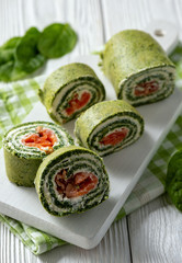 Spinach rolls with smoked salmon and cream cheese.
