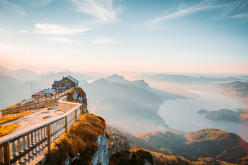 Mountain summit cross on alpine peak at sunset - obrazy, fototapety, plakaty