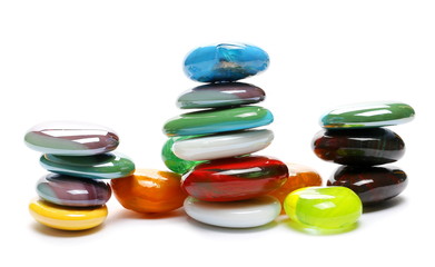 Pile decorative colorful glass pebbles isolated on white background