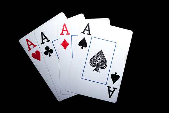 Four aces, playing cards on black table