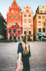 Foto op Canvas Couple follow holding hands traveling together in Stockholm sightseeing walk  vacations lifestyle Stortorget architecture Sweden landmarks © EVERST