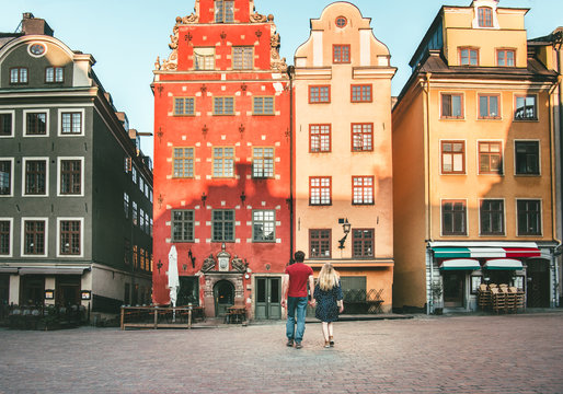 Romantic vacations couple in love traveling together in Stockholm Stortorget architecture colorful houses Sweden landmarks