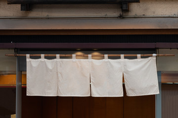 The curtain-like fabric that hangs in front of traditional Japanese restaurants and shops not only serves as a signboard, but holds a larger meaning,