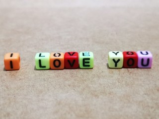 I love you quote blocks toy message with vintage wooden background.