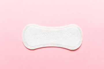 Feminine hygiene pad on a pink background. Concept of feminine hygiene during menstruation. top view. © troyanphoto