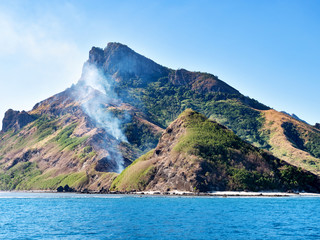 Fototapeta na wymiar Smoke on a mountain on a tropical island