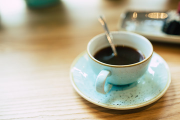 Top view photo the cup of coffee and chocolate cake with berry ice-cream in plate on wooden table 