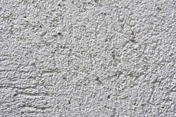 Textured background of white rough cement wall.
