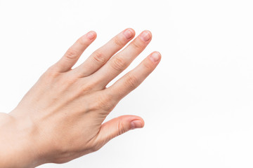 female hand with short nails and neat manicure without varnish on a white background, arthrosis of the joints, normal skin