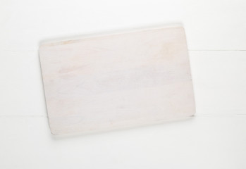 Empty white cutting board on white wooden table background top view from above