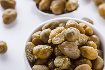 Pickled capers on a white acrylic background