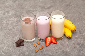Assorted protein cocktails. Strawberry, banana and chocolate protein shakes. Sports nutrition and...