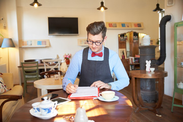 Small business owner businessman sitting at desk and working