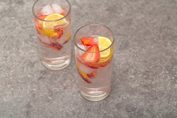 Refreshing Ice Cold Strawberry Lemonade on grey table
