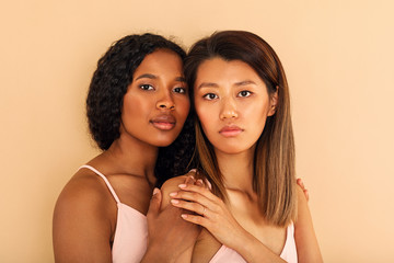Two diverse women friends against a colored background