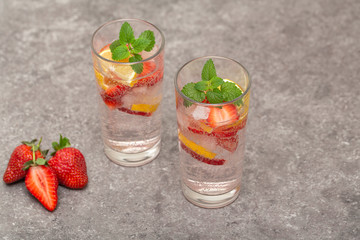 Refreshing Ice Cold Strawberry Lemonade on grey table