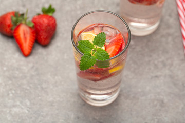 Refreshing Ice Cold Strawberry Lemonade on grey table