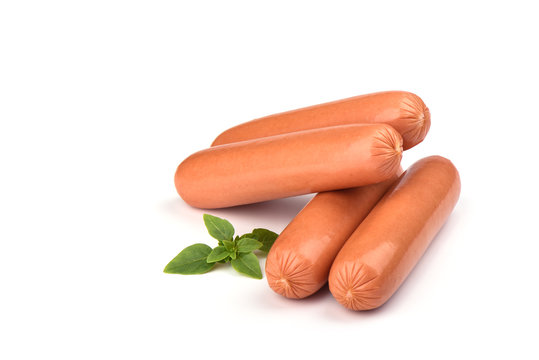 Four fresh boiled sausages with basil isolated on white background.