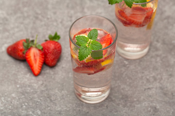 Refreshing Ice Cold Strawberry Lemonade on grey table