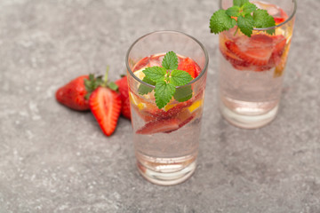 Refreshing Ice Cold Strawberry Lemonade on grey table