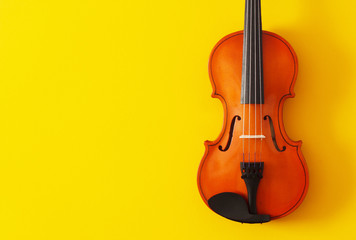 Classical music concert poster with orange color violin on yellow background with copy space for...