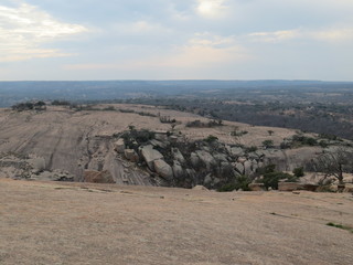 A rocky and desert like landscape at Enchanted Rock State Park in Texas.