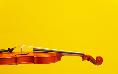 Classical music concert poster with orange color violin on yellow background with copy space for...