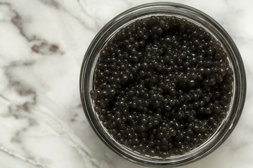 Fototapeta na wymiar Jar with delicious black caviar on grey background. Top view