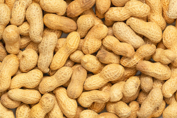Raw peanuts in a shell texture. Food background of peanuts.