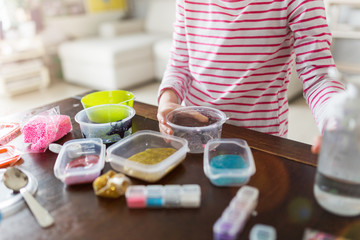 Obraz na płótnie Canvas Little girl making homemade slime toy