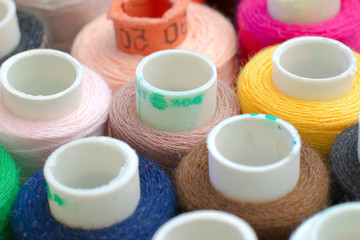 Multicolor sewing threads as background, close up