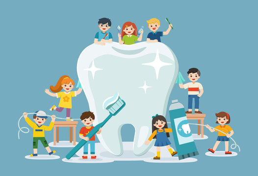 Group of smiling boys and girls standing next to big white tooth holding toothbrush showing healthy clean tooth encouraging teeth hygiene and care.