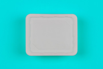 mock-up white plastic box on blue background top view, disposable packaging for products. the concept of the problem of prohibiting the use of plastic packaging