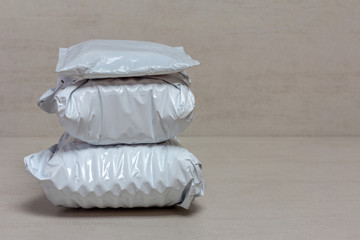 a bunch of grey post packages from Chinese stores close up on a grey background with copy space