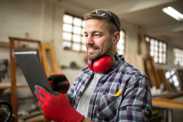 Professional worker in workshop. Young creative man looking for new ideas.