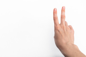 female hand on white background showing the symbol of victory or the number two or sexual insult